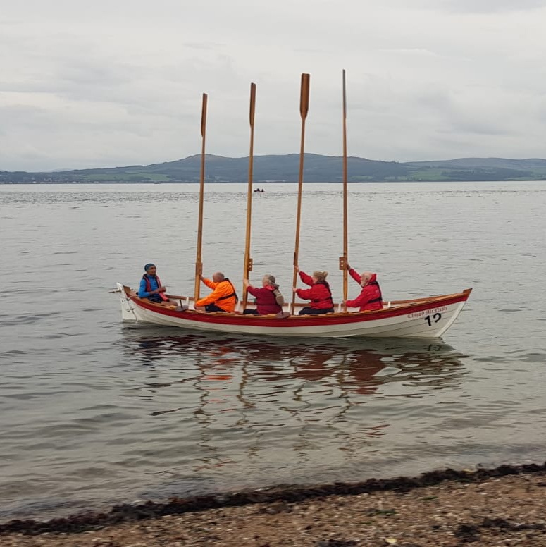 Oars raised for the passing of the Queen